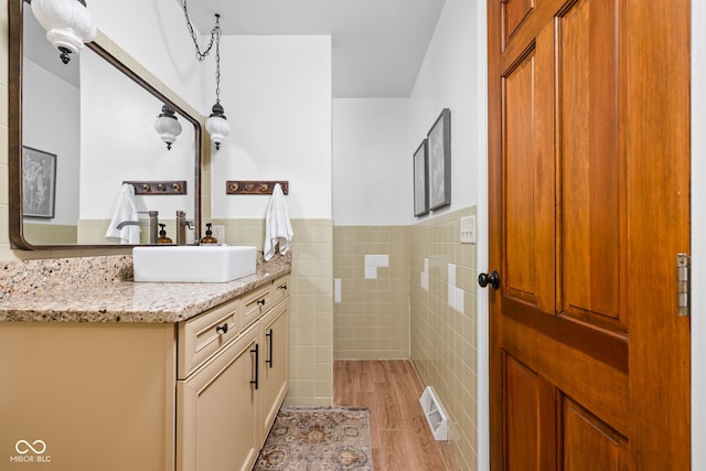 10198 N State Road 75, North Salem, IN 46165 - bathroom featuring tile walls, vanity, wainscoting, and wood finished floors