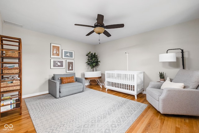 10198 N State Road 75, North Salem, IN 46165 - bedroom featuring light wood-style floors, a crib, and a ceiling fan