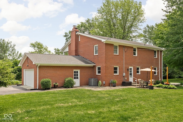 10198 N State Road 75, North Salem, IN 46165 - rear view of house featuring brick siding, a chimney, a lawn, an attached garage, and entry steps