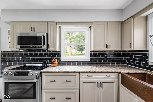 10198 N State Road 75, North Salem, IN 46165 - kitchen featuring stainless steel appliances, tasteful backsplash, and light stone counters