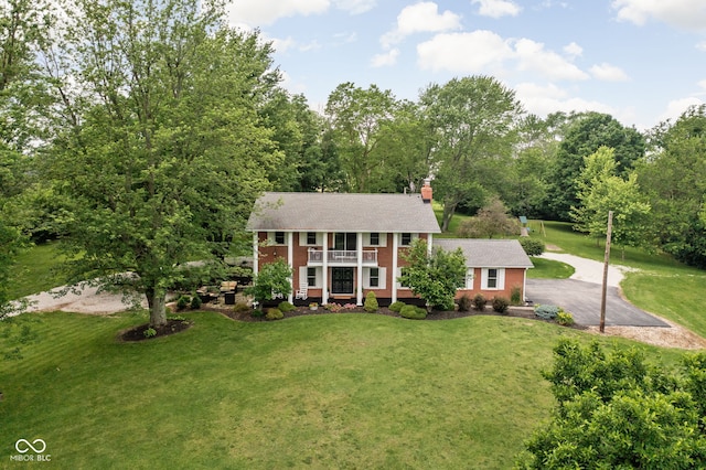 10198 N State Road 75, North Salem, IN 46165 - greek revival house featuring brick siding, a front lawn, asphalt driveway, a chimney, and a shingled roof