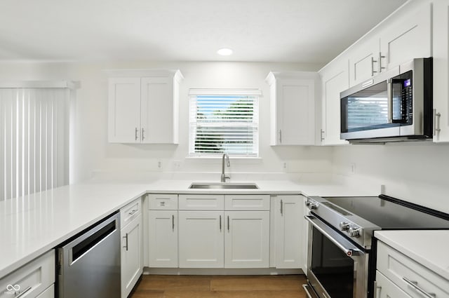 13264 Penneagle Dr, Carmel, IN 46033 - kitchen with stainless steel appliances, white cabinetry, light countertops, and recessed lighting