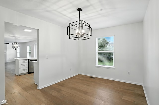 13264 Penneagle Dr, Carmel, IN 46033 - unfurnished dining area with a chandelier and wood finished floors