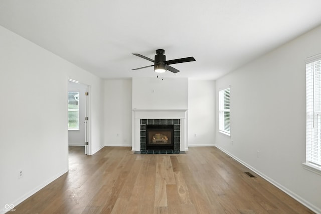 13264 Penneagle Dr, Carmel, IN 46033 - unfurnished living room with wood finished floors, ceiling fan, and a fireplace