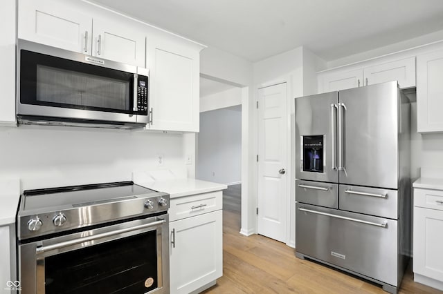13264 Penneagle Dr, Carmel, IN 46033 - kitchen featuring appliances with stainless steel finishes, light wood-style floors, and light countertops