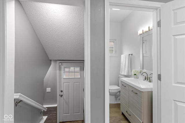1141 W 35th St, Indianapolis, IN 46208 - bathroom featuring vanity, wood finished floors, and a textured ceiling