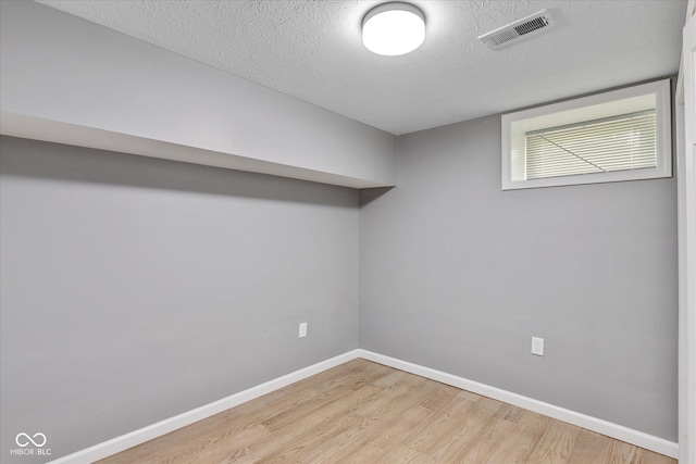 1141 W 35th St, Indianapolis, IN 46208 - below grade area with light wood-type flooring and a textured ceiling