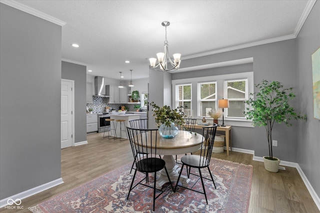 1141 W 35th St, Indianapolis, IN 46208 - dining space featuring light wood-style floors, a chandelier, ornamental molding, and recessed lighting