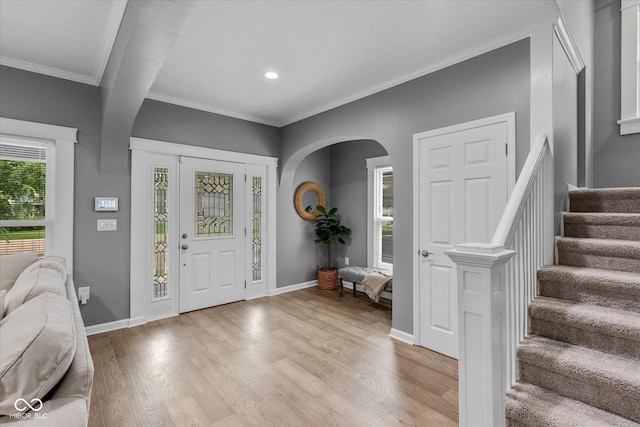 1141 W 35th St, Indianapolis, IN 46208 - foyer with ornamental molding, stairway, light wood-style flooring, arched walkways, and recessed lighting