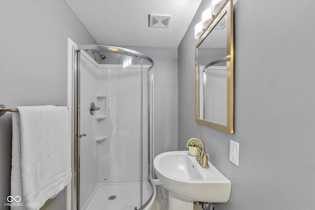 1141 W 35th St, Indianapolis, IN 46208 - bathroom featuring a stall shower and a textured ceiling