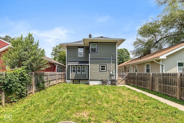 1141 W 35th St, Indianapolis, IN 46208 - rear view of house featuring a fenced backyard and a chimney