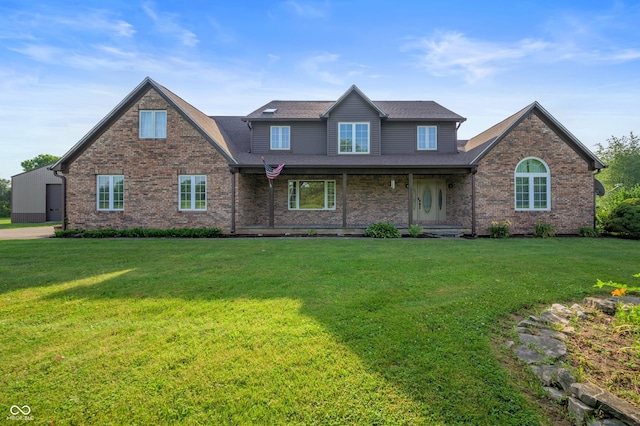 8594 N 900 W, Carthage, IN 46115 - view of front of home with brick siding, a front yard, and covered porch