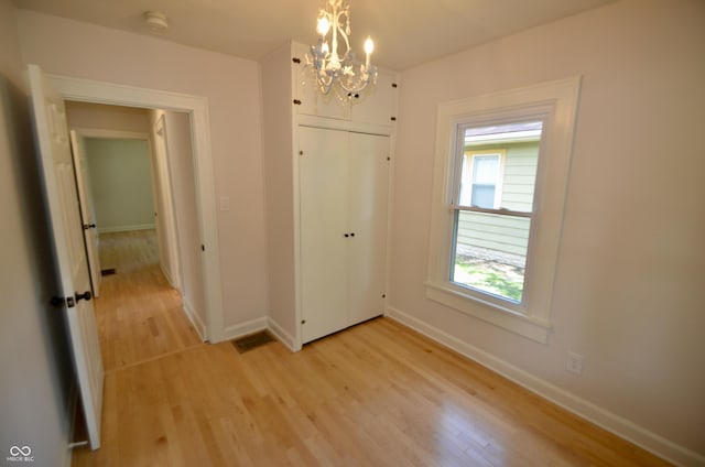 4930 Primrose Ave N, Indianapolis, IN 46205 - unfurnished dining area featuring a chandelier and light wood finished floors