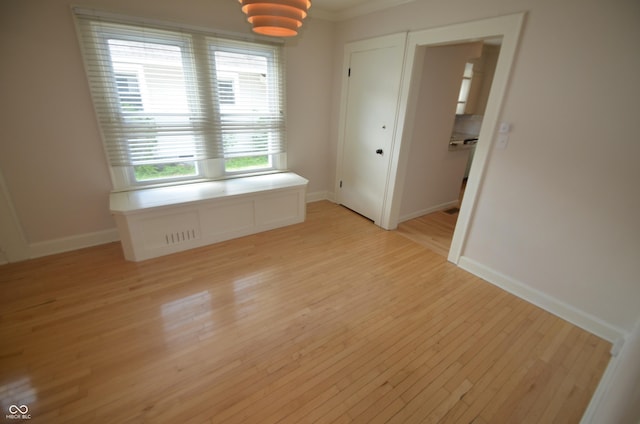 4930 Primrose Ave N, Indianapolis, IN 46205 - spare room with light wood finished floors and crown molding