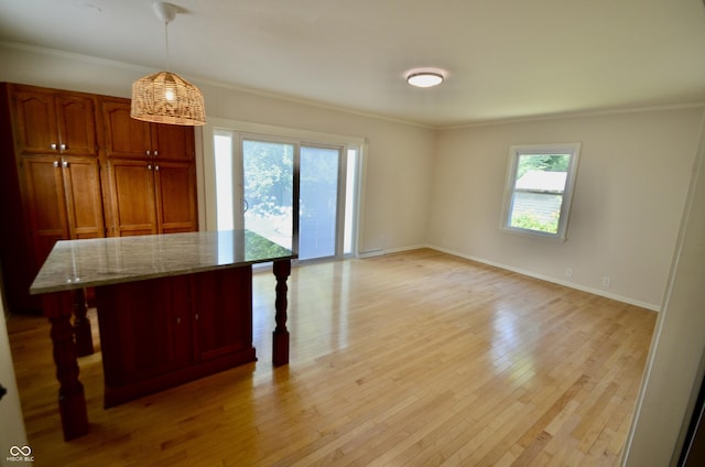 4930 Primrose Ave N, Indianapolis, IN 46205 - kitchen with a breakfast bar area, healthy amount of natural light, crown molding, and light stone countertops