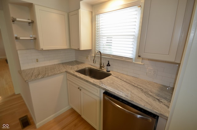 4930 Primrose Ave N, Indianapolis, IN 46205 - kitchen featuring dishwasher, open shelves, light wood-type flooring, backsplash, and white cabinets
