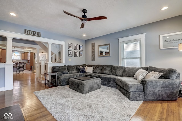 2332 Central Ave, Indianapolis, IN 46205 - living area with a ceiling fan, light wood-style flooring, stairs, recessed lighting, and decorative columns