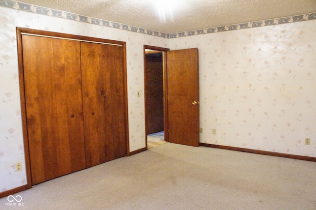 3401 N 75 W, Cayuga, IN 47928 - unfurnished bedroom with a closet, carpet, wallpapered walls, and a textured ceiling