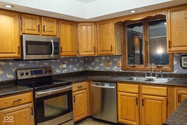 3401 N 75 W, Cayuga, IN 47928 - kitchen with stainless steel appliances, wallpapered walls, dark countertops, and brown cabinets