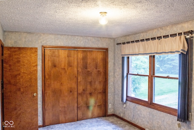 3401 N 75 W, Cayuga, IN 47928 - unfurnished bedroom featuring a closet, a textured ceiling, and carpet