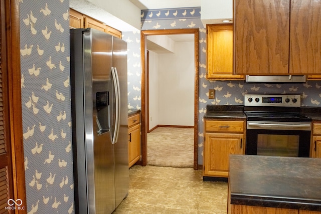 3401 N 75 W, Cayuga, IN 47928 - kitchen with stainless steel appliances, wallpapered walls, dark countertops, ventilation hood, and brown cabinets