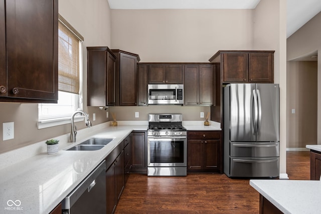 1418 Blackthorne Trl S, Plainfield, IN 46168 - kitchen with appliances with stainless steel finishes, dark brown cabinets, light countertops, and dark wood finished floors