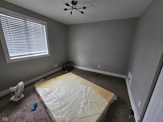 3836 N Wittfield St, Indianapolis, IN 46235 - carpeted spare room featuring baseboards and a chandelier