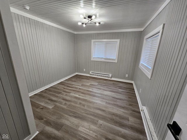 3836 N Wittfield St, Indianapolis, IN 46235 - empty room with a baseboard radiator, baseboard heating, crown molding, wood finished floors, and a chandelier