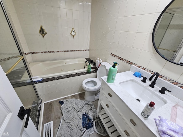 3836 N Wittfield St, Indianapolis, IN 46235 - full bath featuring tile walls, a whirlpool tub, wood finished floors, and vanity