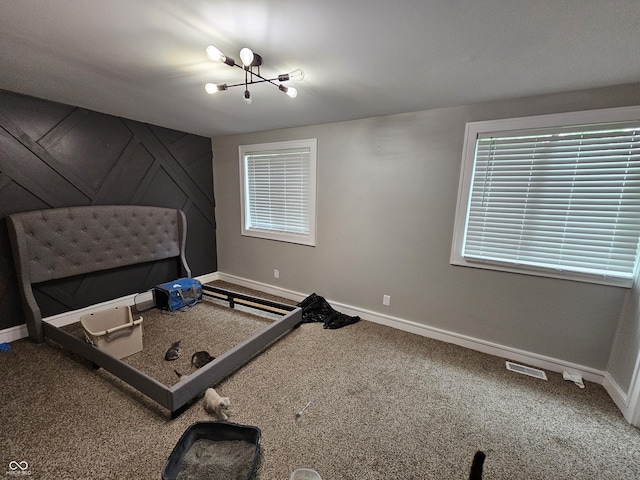 3836 N Wittfield St, Indianapolis, IN 46235 - carpeted bedroom with baseboards and a chandelier