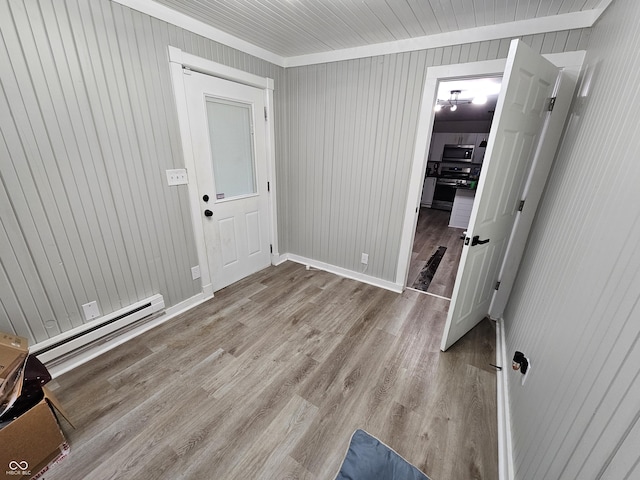 3836 N Wittfield St, Indianapolis, IN 46235 - entryway featuring baseboard heating, wood finished floors, wooden walls, and ornamental molding