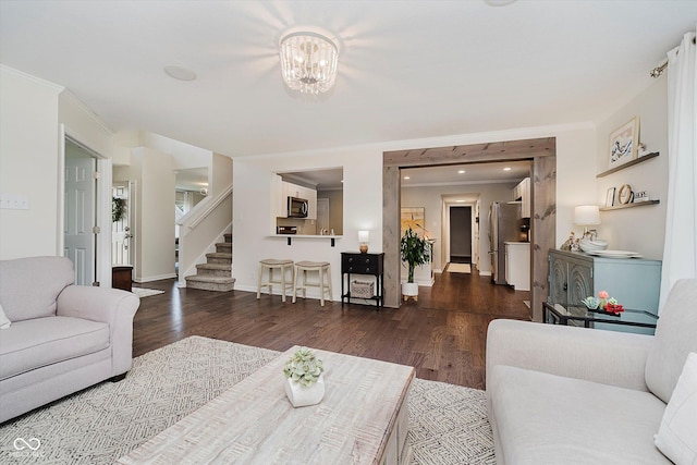 6036 W Bayfront Shrs, Mccordsville, IN 46055 - living area featuring wood finished floors, stairway, a chandelier, and ornamental molding