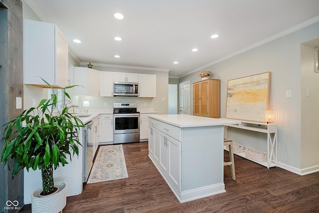 6036 W Bayfront Shrs, Mccordsville, IN 46055 - kitchen with appliances with stainless steel finishes, ornamental molding, recessed lighting, dark wood-type flooring, and white cabinets