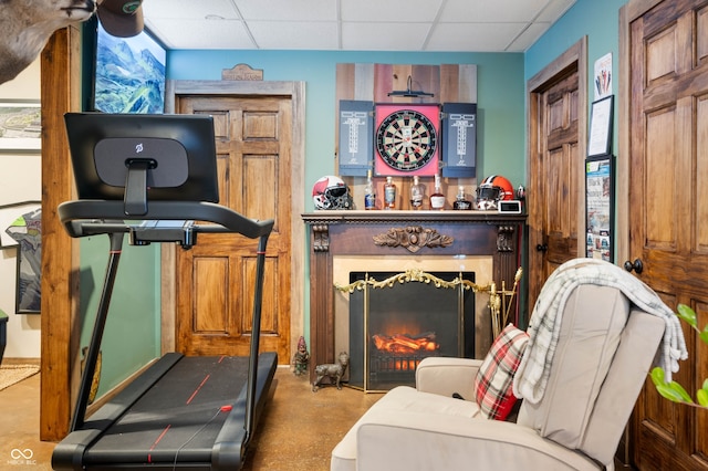 6420 Colt Ln, Anderson, IN 46013 - exercise room with a drop ceiling and a lit fireplace