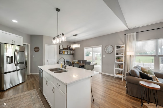 6420 Colt Ln, Anderson, IN 46013 - kitchen featuring stainless steel appliances, open floor plan, light countertops, dark wood finished floors, and a kitchen island with sink