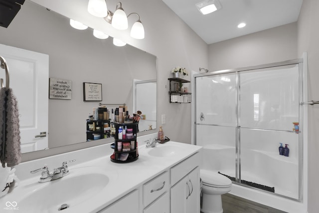 757 Carson Ln, Greenfield, IN 46140 - bathroom featuring a stall shower, double vanity, wood finished floors, and recessed lighting