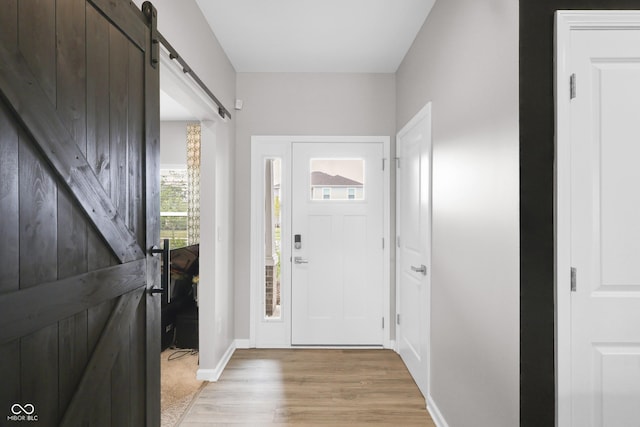 757 Carson Ln, Greenfield, IN 46140 - foyer with a barn door and light wood-style flooring