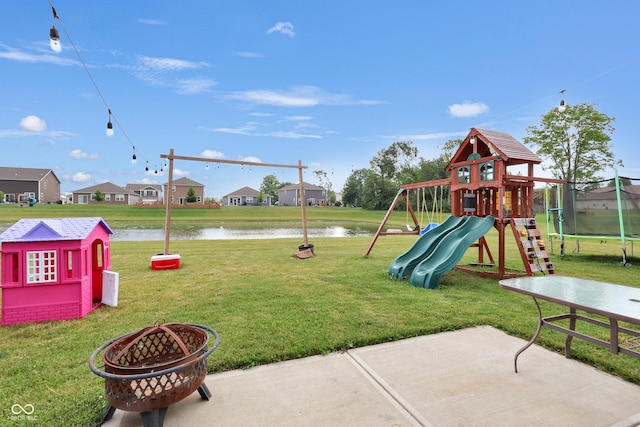 757 Carson Ln, Greenfield, IN 46140 - view of play area with a water view, a lawn, a patio area, a trampoline, and an outdoor fire pit