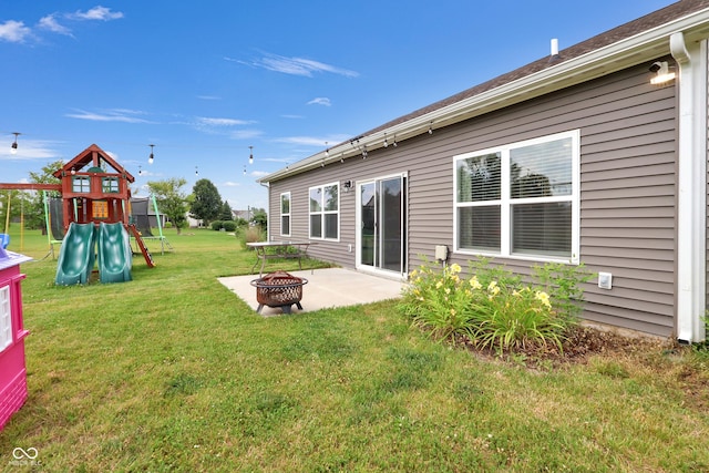 757 Carson Ln, Greenfield, IN 46140 - view of grassy yard with a fire pit, a playground, and a patio area