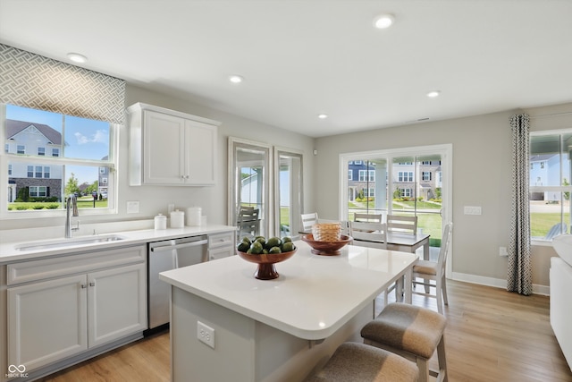 4182 Hume Ave, Plainfield, IN 46168 - kitchen featuring dishwasher, light wood-style floors, a breakfast bar area, light countertops, and recessed lighting