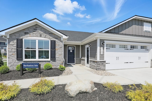 4182 Hume Ave, Plainfield, IN 46168 - view of front of home featuring stone siding, concrete driveway, board and batten siding, and a garage