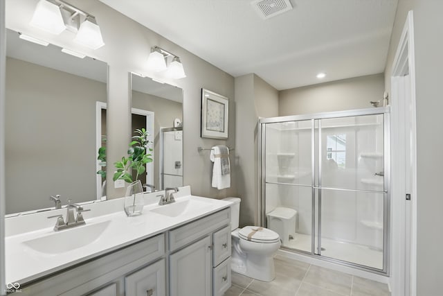4182 Hume Ave, Plainfield, IN 46168 - full bathroom with double vanity, a shower stall, tile patterned flooring, and recessed lighting