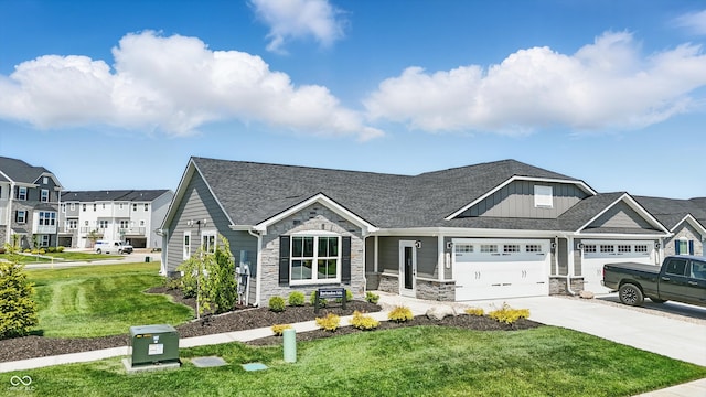 4182 Hume Ave, Plainfield, IN 46168 - view of front of property with stone siding, concrete driveway, a front yard, roof with shingles, and board and batten siding