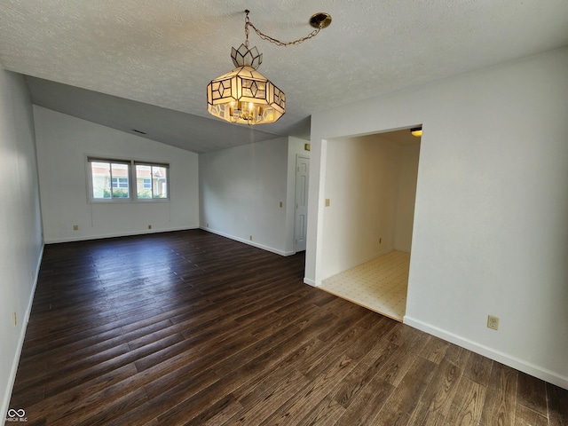 3415 Winchester Dr, Indianapolis, IN 46227 - unfurnished room featuring dark wood-type flooring, a textured ceiling, and a chandelier