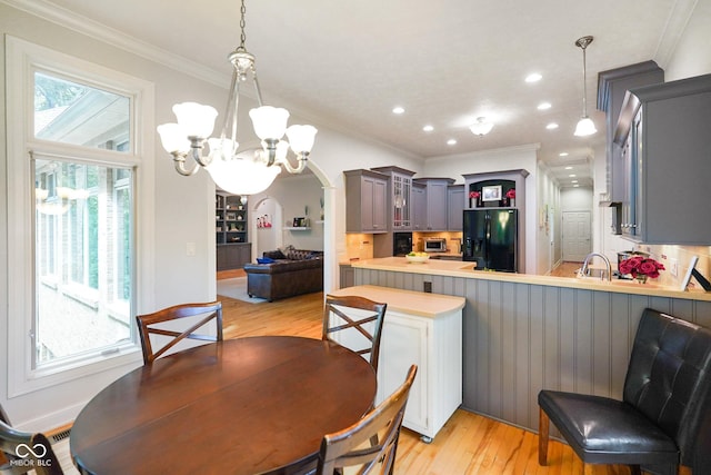 5720 Hickory Hollow Dr, Plainfield, IN 46168 - dining area with a chandelier, light wood finished floors, plenty of natural light, arched walkways, and recessed lighting