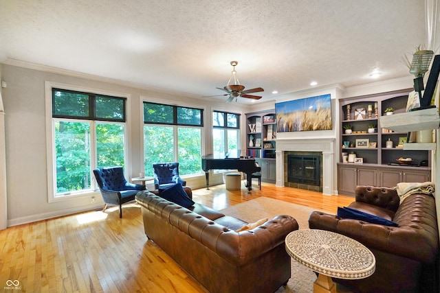 5720 Hickory Hollow Dr, Plainfield, IN 46168 - living area with ornamental molding, healthy amount of natural light, ceiling fan, a textured ceiling, and light wood-type flooring