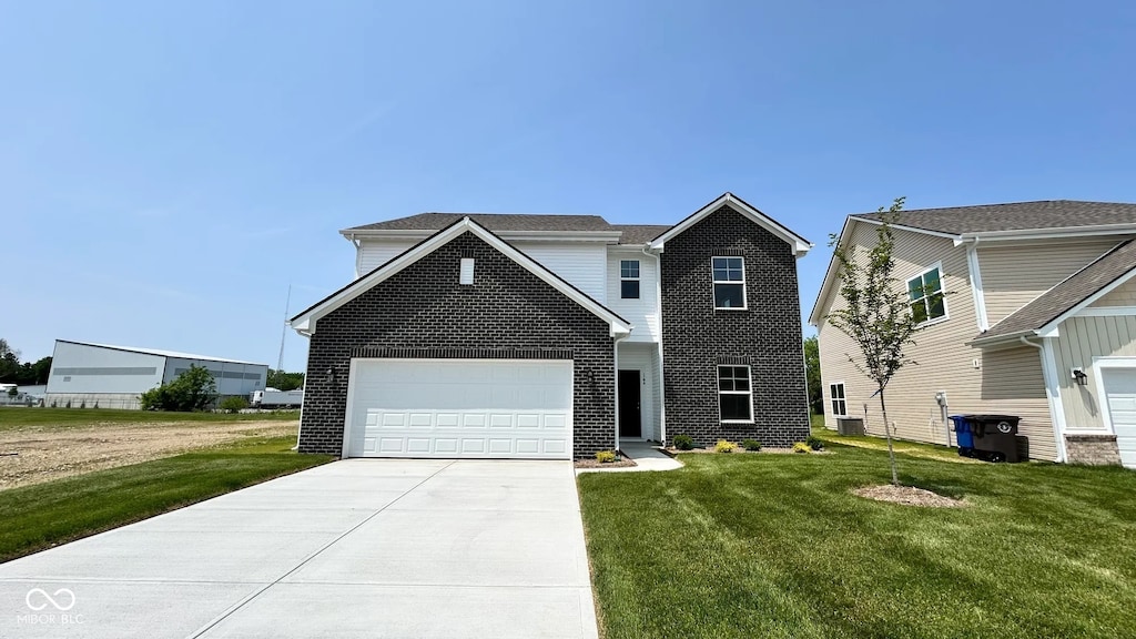164 Luna Pl, Shelbyville, IN 46176 - traditional-style house featuring a garage, a front yard, and driveway