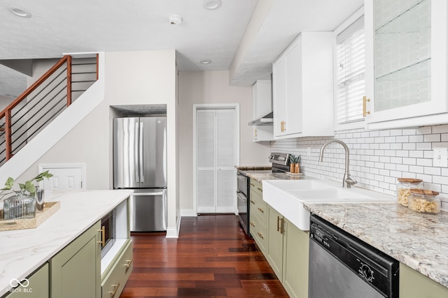 2015 N College Ave, Indianapolis, IN 46202 - kitchen with green cabinets, stainless steel appliances, dark wood finished floors, backsplash, and light stone counters