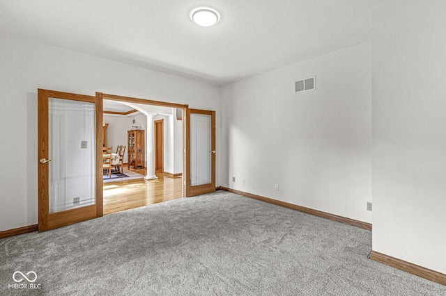 3766 Brill Rd, Indianapolis, IN 46227 - spare room featuring carpet, ornate columns, french doors, and arched walkways