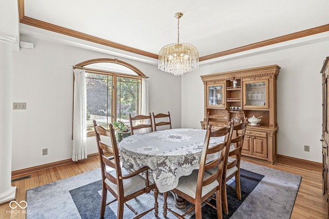 3766 Brill Rd, Indianapolis, IN 46227 - dining room with a chandelier, light wood-style floors, and crown molding